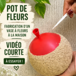 Un vase fait maison en argile décoré de fleurs colorées