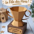 Un trophée en papier 3D coloré pour la fête des pères, décoré avec des motifs et un message d'amour.